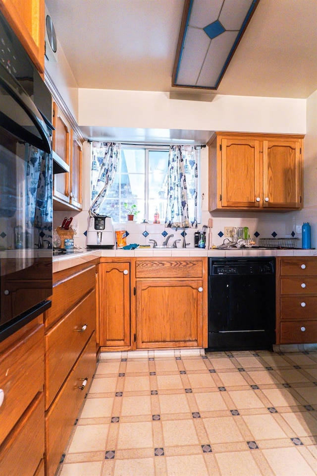 kitchen featuring sink and black appliances