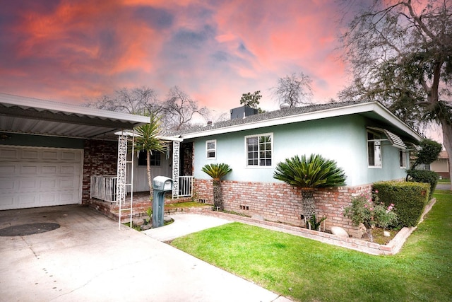 view of front of house featuring a carport, a garage, and a lawn