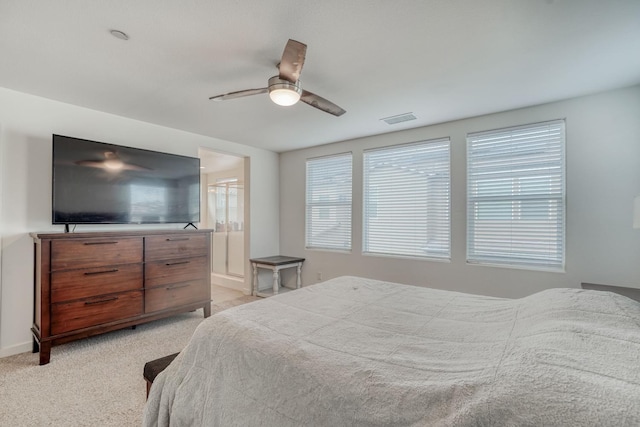 carpeted bedroom featuring ceiling fan and ensuite bathroom