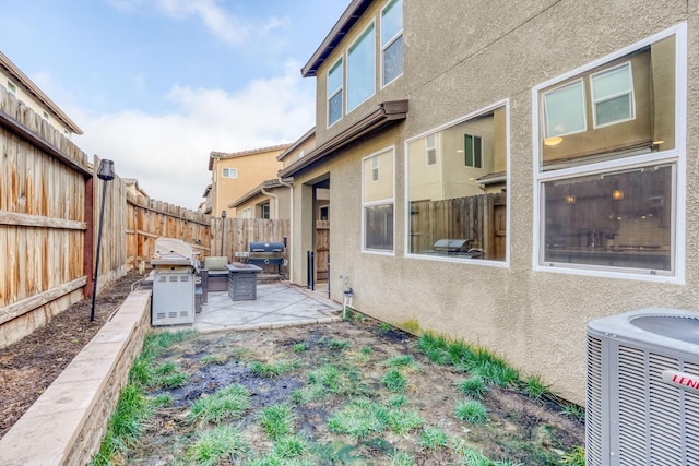 view of yard featuring central air condition unit and a patio