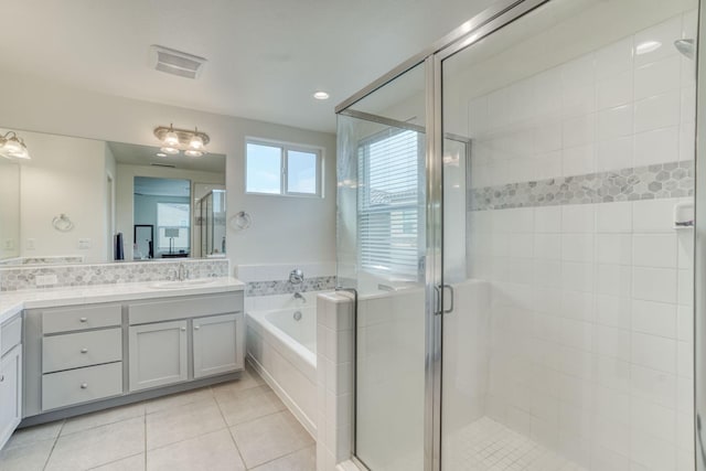 bathroom with tile patterned floors, separate shower and tub, and vanity