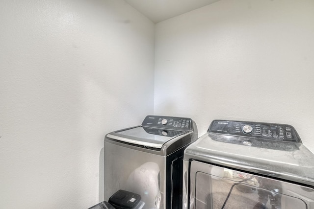 clothes washing area featuring separate washer and dryer