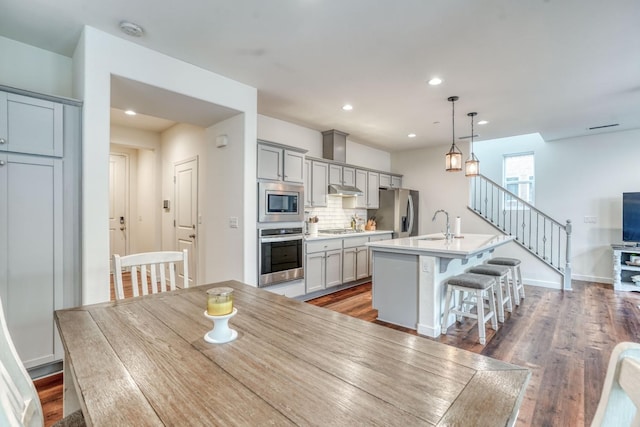 dining area with sink and dark hardwood / wood-style floors