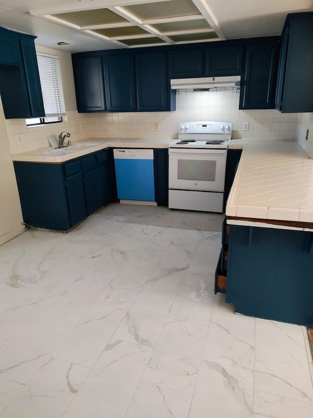 kitchen with sink, white appliances, and blue cabinets