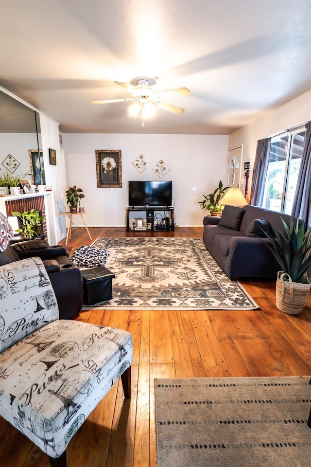 living room with ceiling fan and wood-type flooring