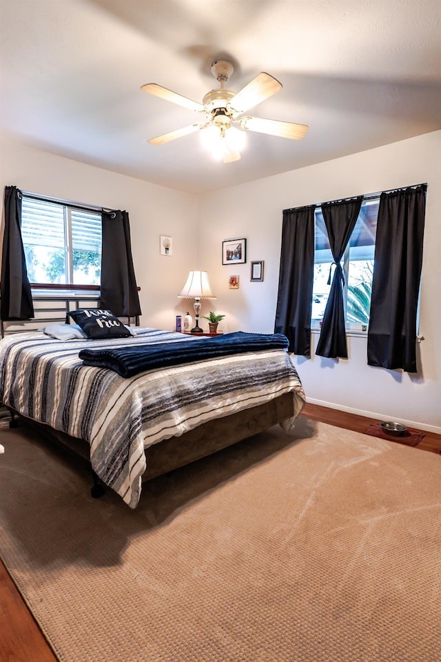 bedroom featuring hardwood / wood-style flooring and ceiling fan