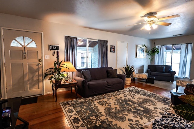 living room featuring hardwood / wood-style flooring and ceiling fan