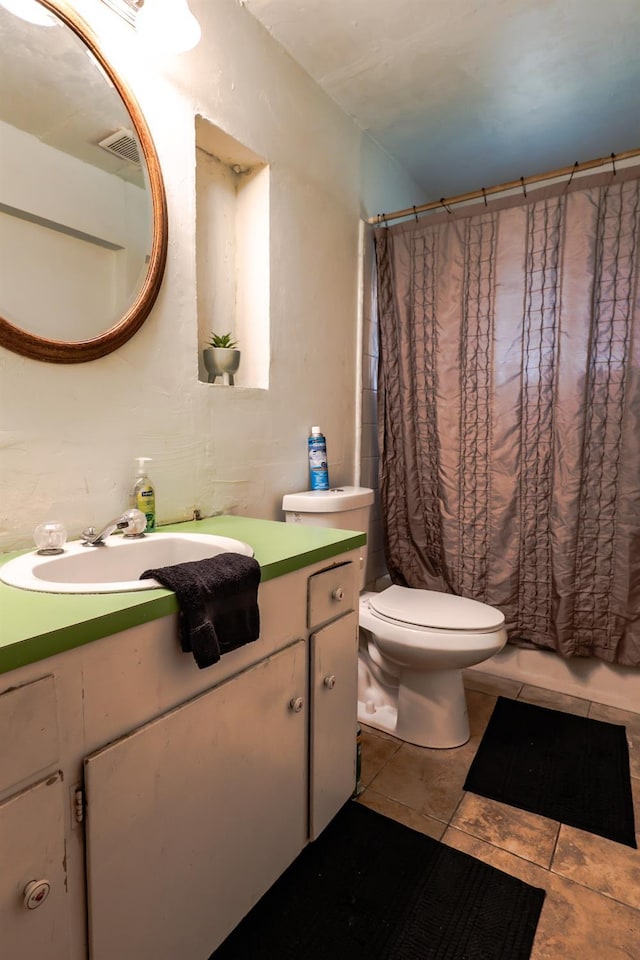 bathroom featuring tile patterned flooring, vanity, and toilet