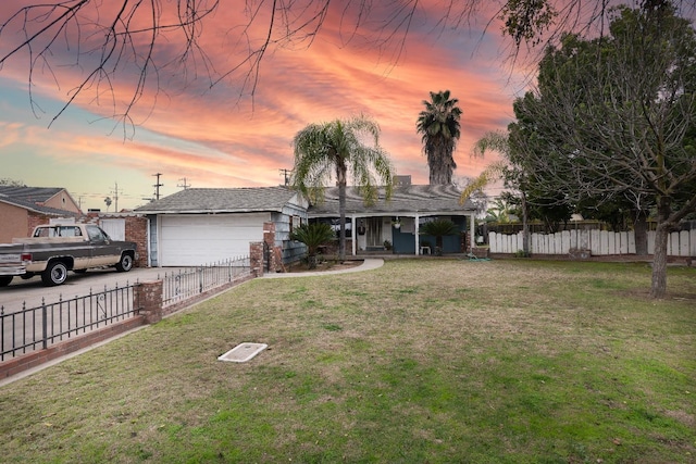 single story home featuring a garage and a lawn