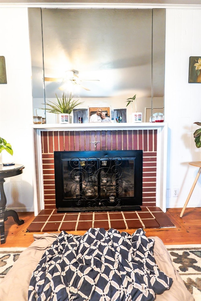 details with hardwood / wood-style floors and a brick fireplace