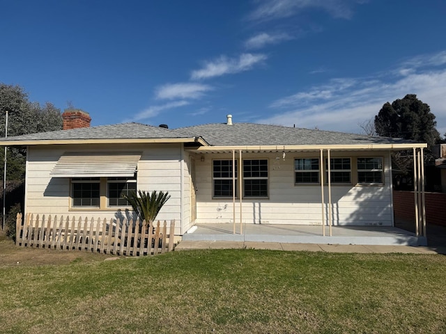 back of property featuring a yard