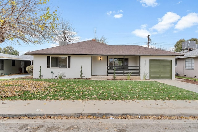 view of front of house featuring a porch, a front yard, and a garage