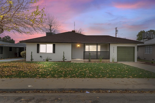 view of front facade with a lawn and a garage