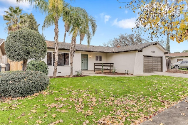 ranch-style house featuring a front yard and a garage