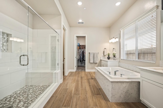 bathroom with vanity and separate shower and tub