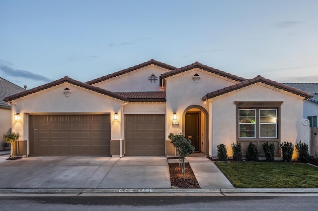 mediterranean / spanish-style house with a garage