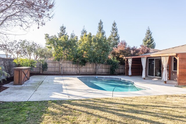 view of swimming pool featuring a yard and a patio