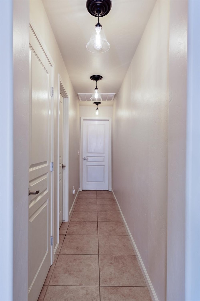 corridor with light tile patterned floors