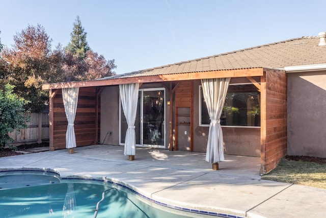 exterior space with a fenced in pool and a patio area