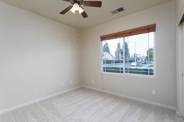 spare room featuring carpet flooring and ceiling fan