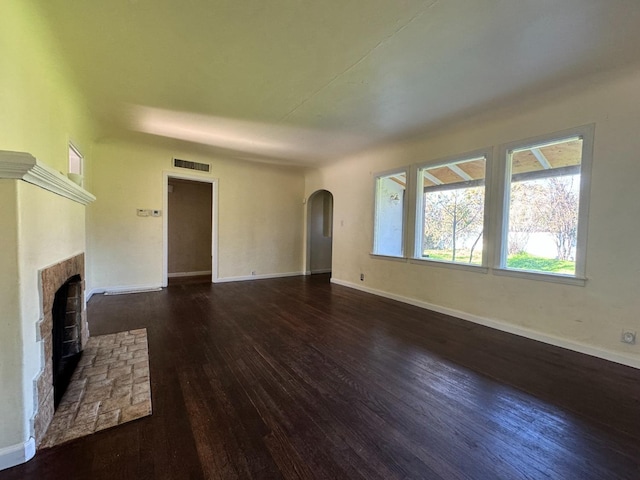 unfurnished living room with dark hardwood / wood-style flooring