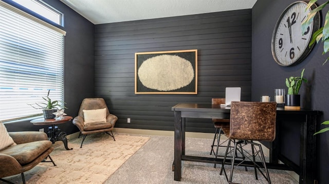 office featuring wood walls and light colored carpet