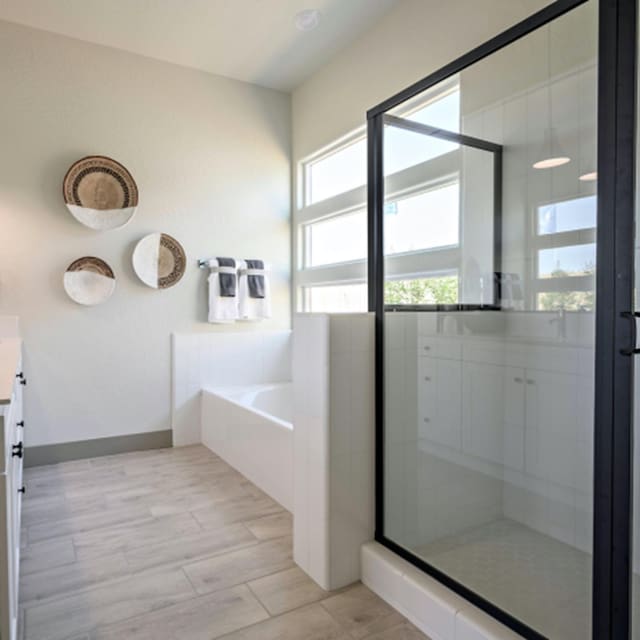 bathroom with plus walk in shower and vanity