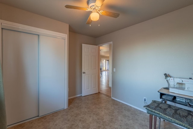 unfurnished office featuring ceiling fan and baseboards