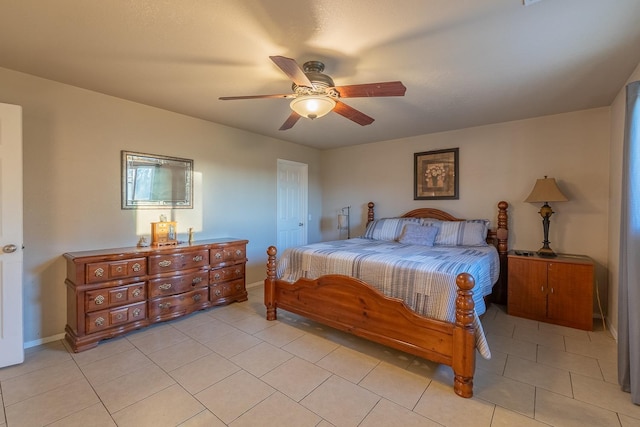 bedroom featuring ceiling fan, baseboards, and light tile patterned flooring