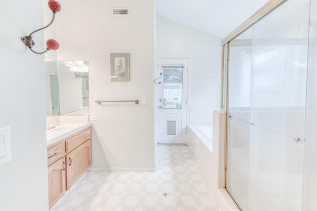 bathroom with vanity, lofted ceiling, and plus walk in shower