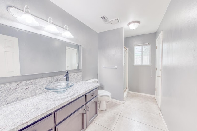 bathroom featuring a shower, tile patterned flooring, vanity, and toilet