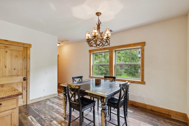 dining space featuring dark hardwood / wood-style floors and an inviting chandelier