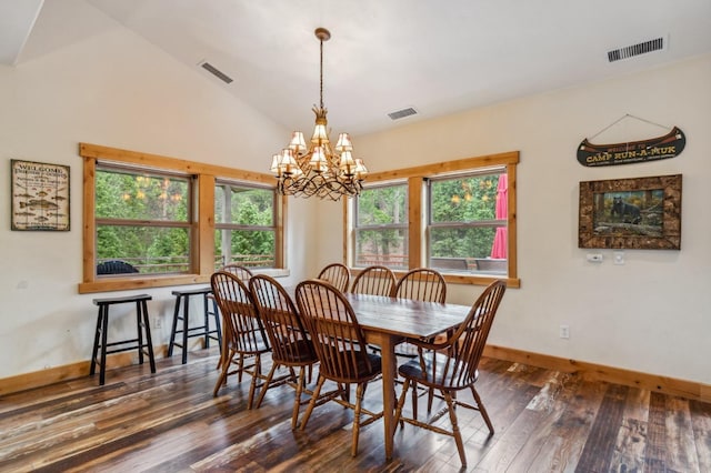 dining space featuring dark hardwood / wood-style floors, lofted ceiling, and an inviting chandelier