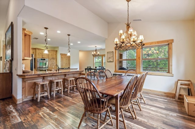 dining area featuring a notable chandelier, dark wood-type flooring, and vaulted ceiling