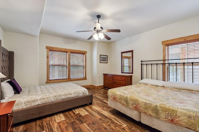 bedroom with ceiling fan and dark wood-type flooring