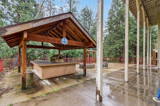 view of patio / terrace with a gazebo, area for grilling, and exterior kitchen