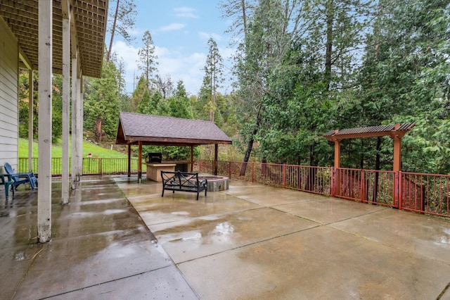 view of patio / terrace with a pergola, a gazebo, and a fire pit