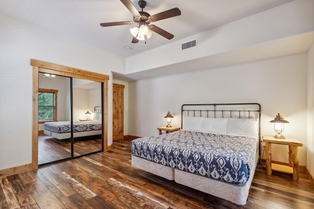 bedroom featuring ceiling fan, a closet, and dark wood-type flooring