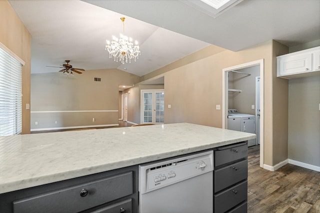 kitchen with dark wood-style floors, lofted ceiling, open floor plan, washer and dryer, and dishwasher