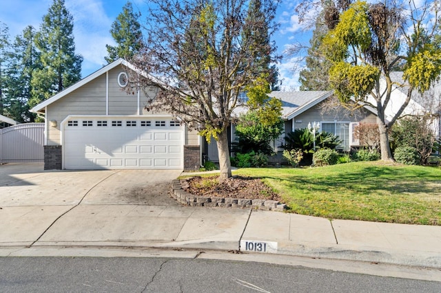 view of front of house with a garage, a gate, a front lawn, and concrete driveway