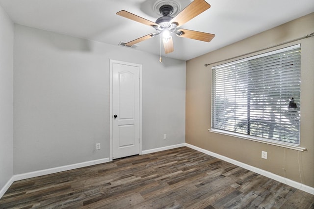 spare room with visible vents, ceiling fan, baseboards, and wood finished floors