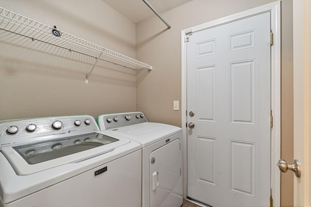 laundry room with laundry area and washer and clothes dryer