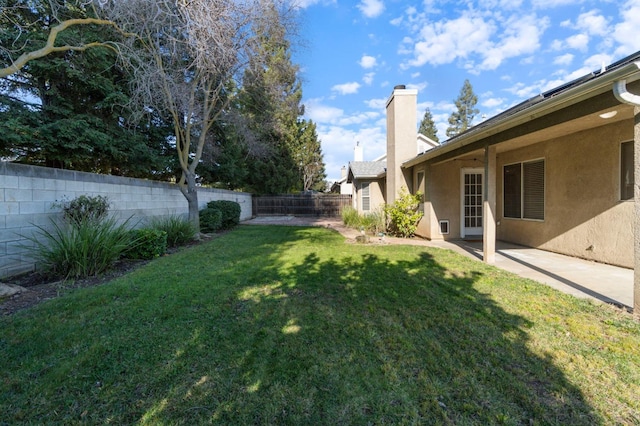 view of yard featuring a patio area and a fenced backyard