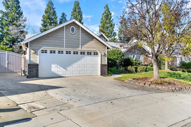 view of front of property featuring a garage, a front yard, stone siding, and fence