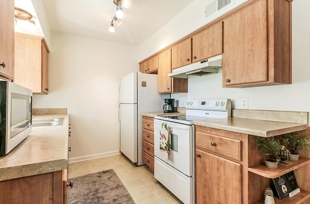 kitchen featuring track lighting and white appliances