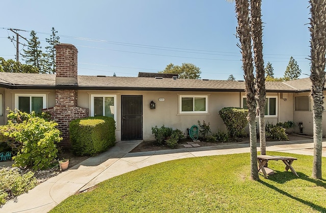 ranch-style home with a front lawn