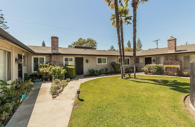 ranch-style home featuring a front yard