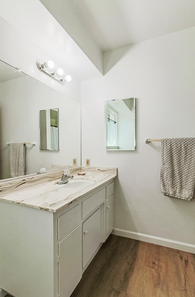 bathroom with hardwood / wood-style floors and vanity