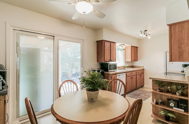 dining space featuring ceiling fan, a wealth of natural light, and sink