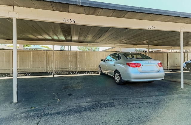 view of parking / parking lot featuring a carport